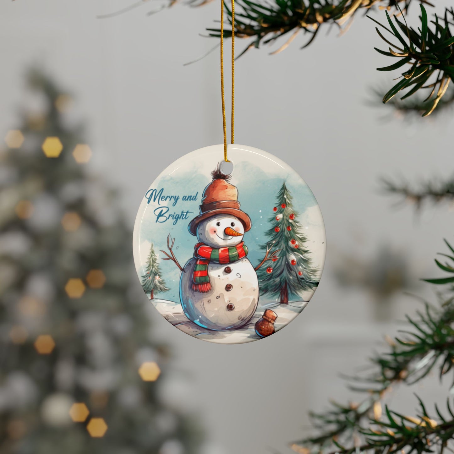 Custom Christmas ornament hanging on pine tree branch with twinkling lights