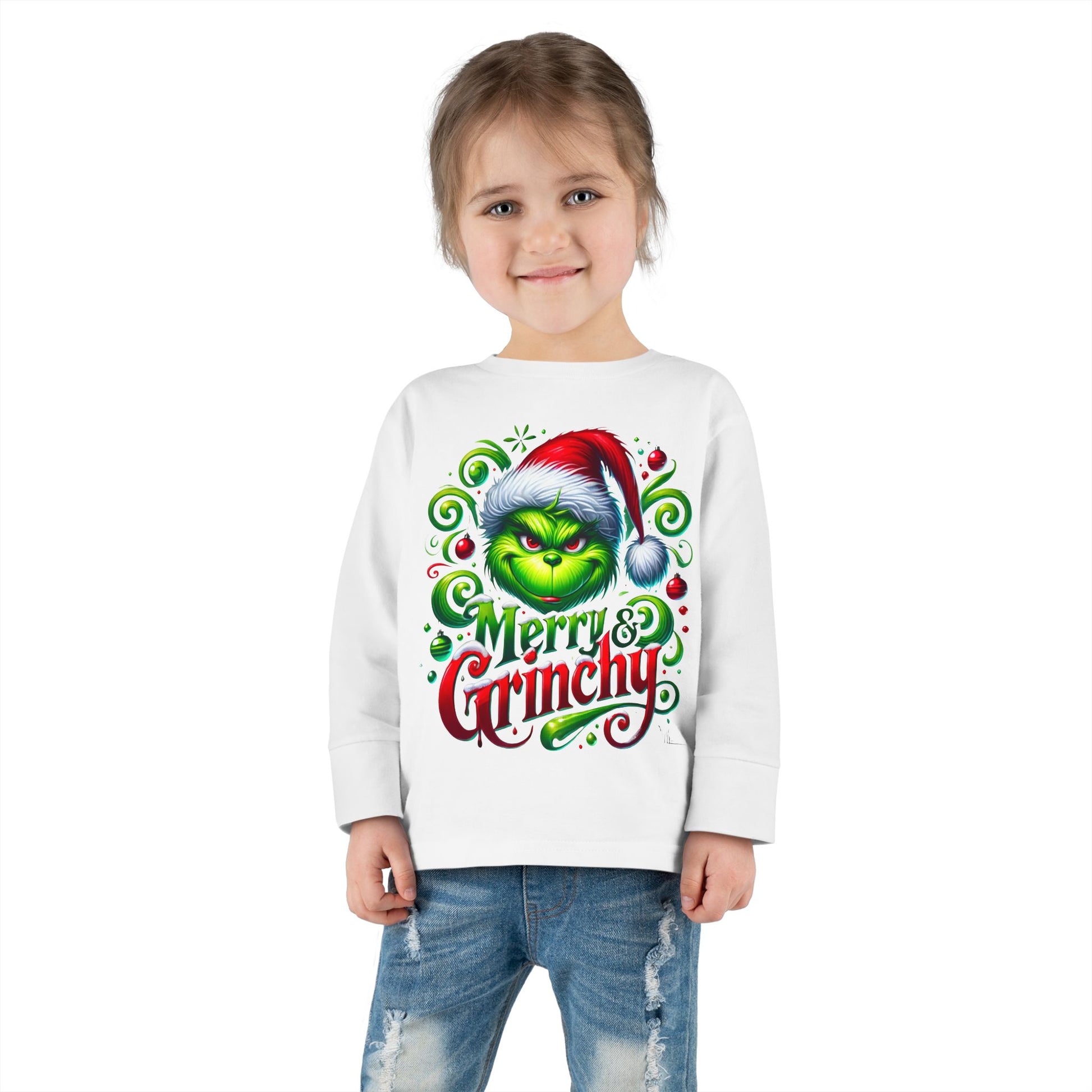 A toddler wearing a Merry Christmas Grinchy graphic tee