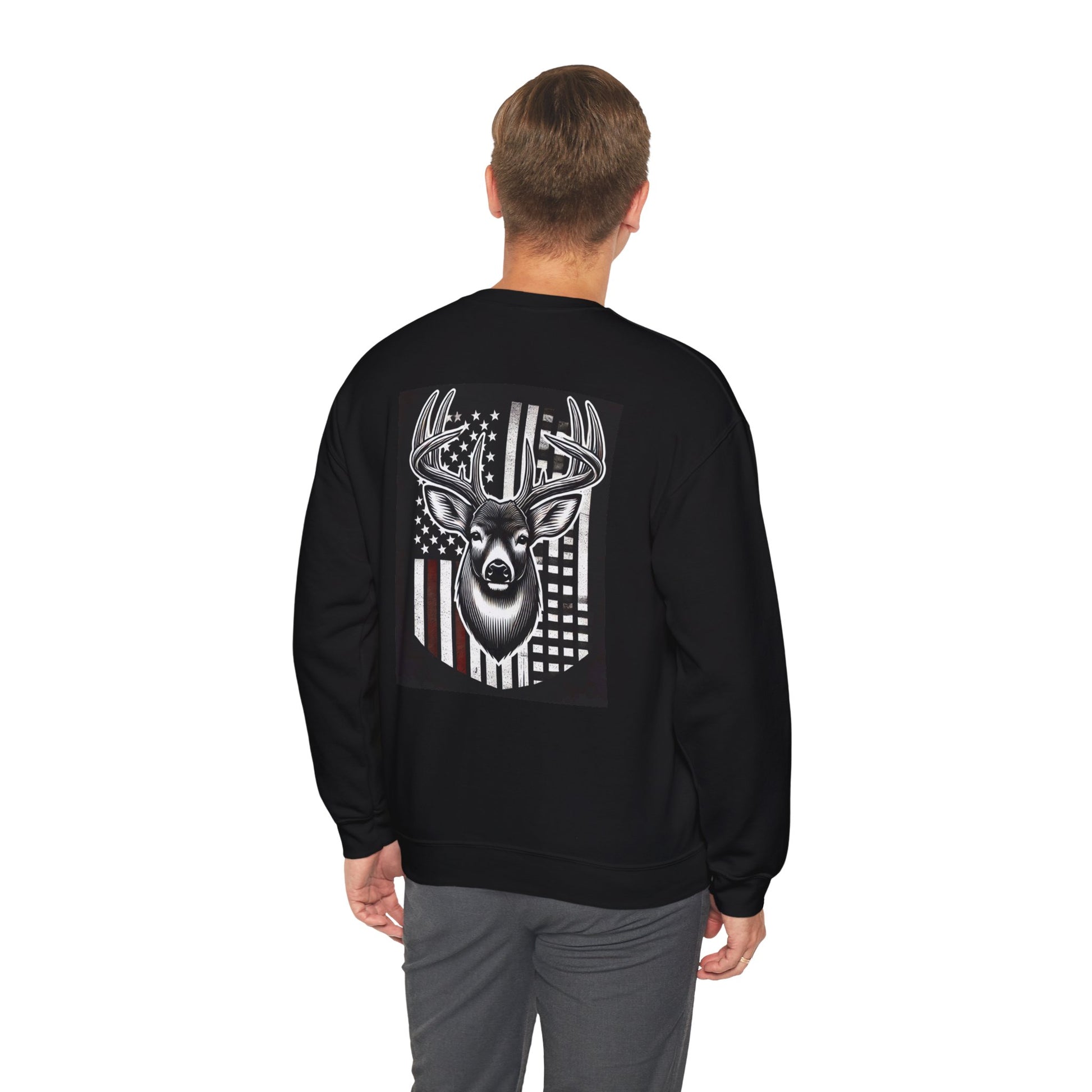 Man wearing a black shirt with graphic design of american flag and buck with jeans